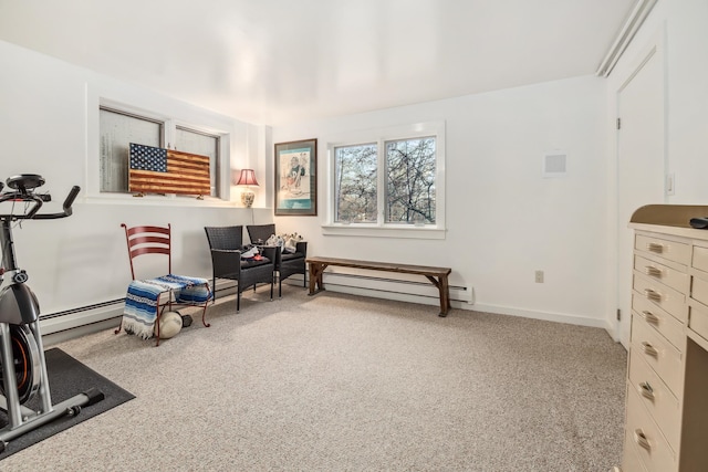 living area with light colored carpet and baseboard heating