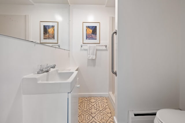 bathroom featuring vanity, toilet, and a baseboard radiator