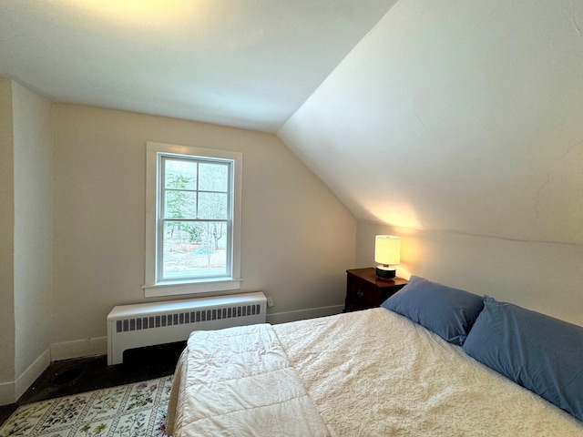 bedroom with radiator and vaulted ceiling