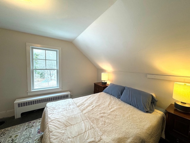 bedroom featuring radiator heating unit and vaulted ceiling