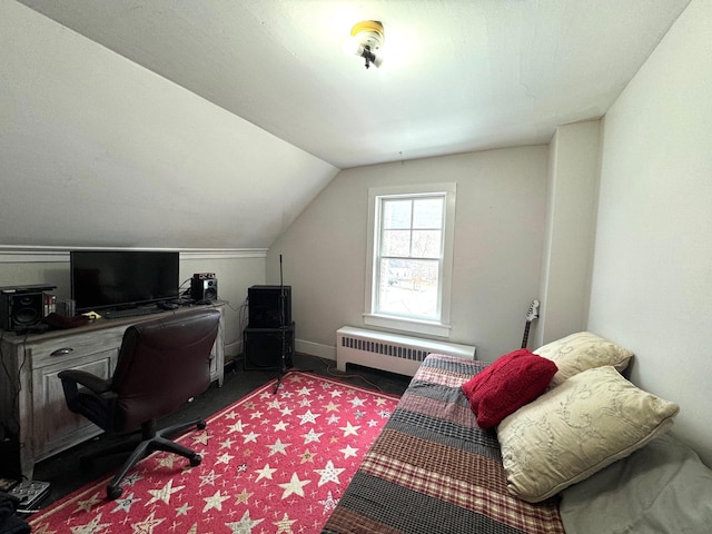 office space with radiator heating unit and lofted ceiling