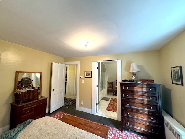 bedroom with radiator heating unit and dark wood-type flooring