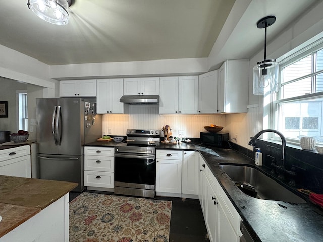 kitchen featuring pendant lighting, white cabinets, stainless steel appliances, and sink