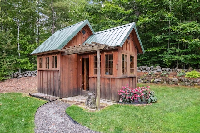 view of outbuilding featuring a yard