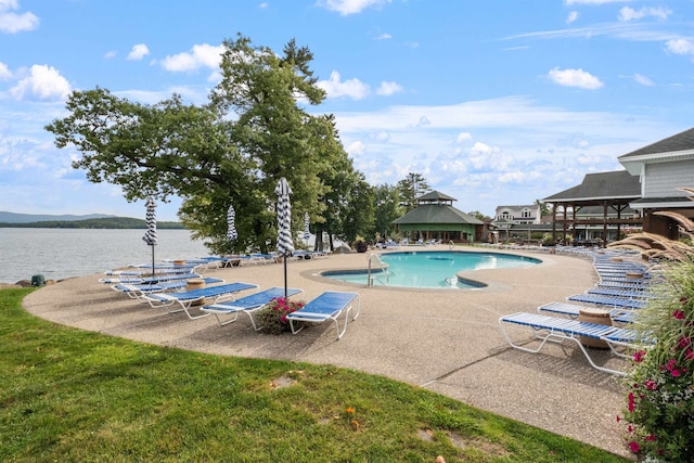 view of swimming pool featuring a gazebo, a patio area, and a water view