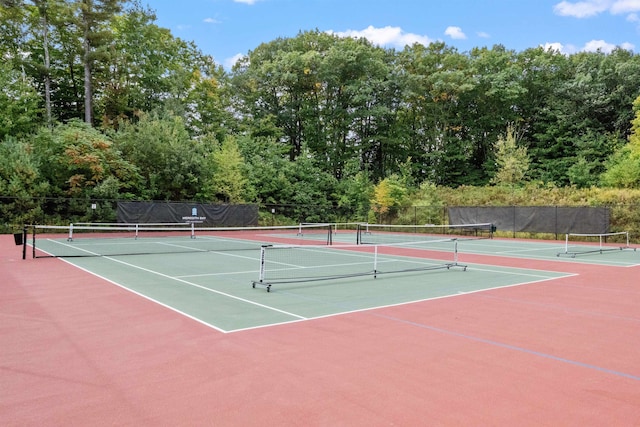 view of tennis court featuring basketball hoop