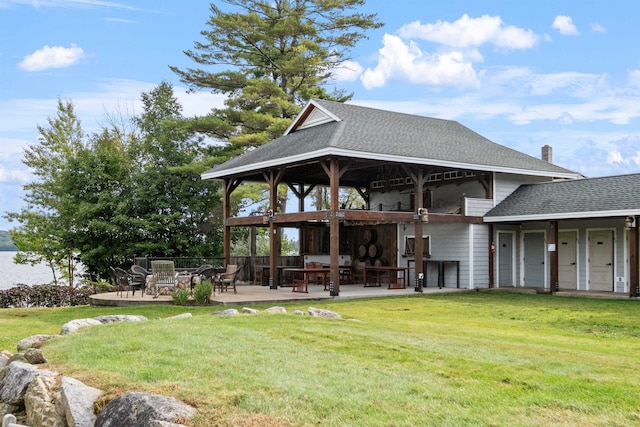 back of house with a patio area and a lawn