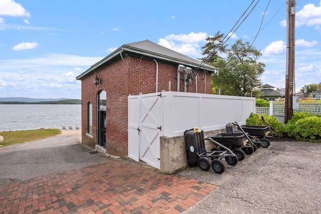 view of property exterior with a water view