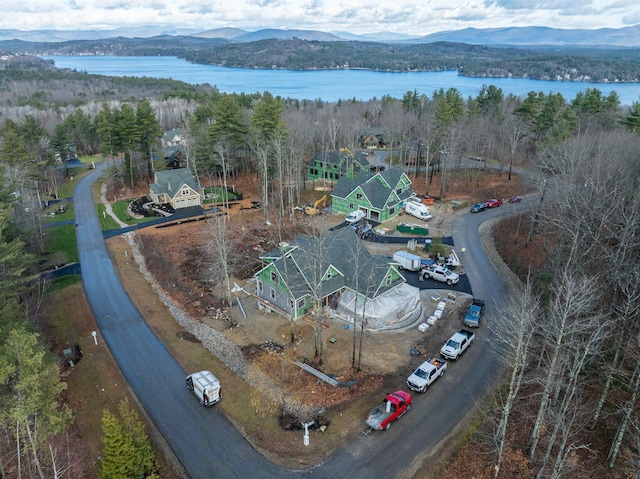 drone / aerial view featuring a water and mountain view