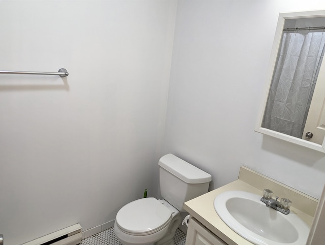 bathroom featuring vanity, toilet, and a baseboard heating unit