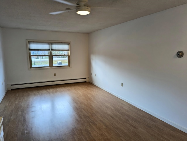 spare room featuring a baseboard heating unit, a textured ceiling, wood-type flooring, and ceiling fan