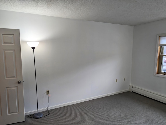 carpeted empty room with a textured ceiling and baseboard heating