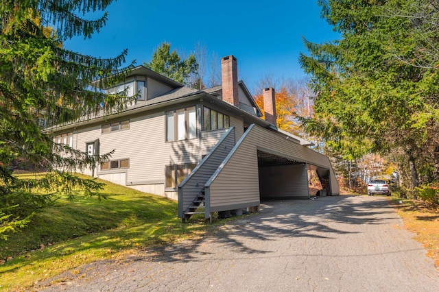 view of side of home with a carport