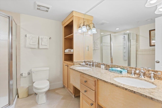 bathroom featuring tile patterned flooring, vanity, toilet, and an enclosed shower