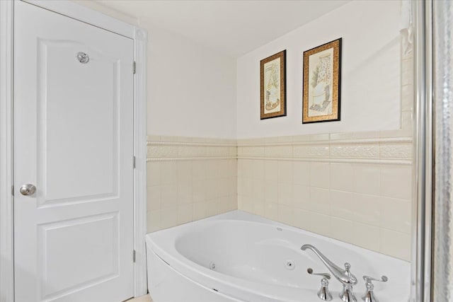 bathroom featuring tile walls and a bathing tub