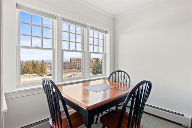 dining space featuring baseboard heating, plenty of natural light, and crown molding