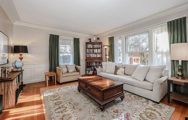 living room featuring ornamental molding and light hardwood / wood-style flooring