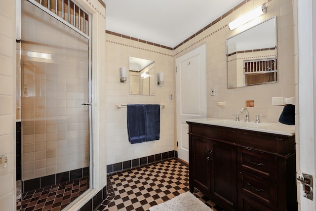 bathroom featuring tile walls, an enclosed shower, and vanity