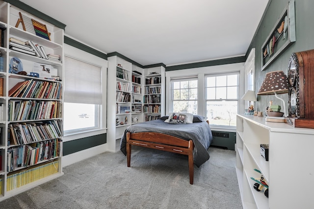 bedroom with radiator heating unit and light colored carpet