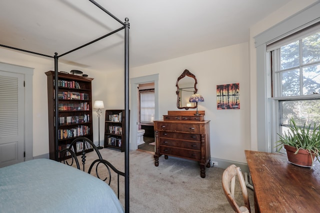 carpeted bedroom with connected bathroom