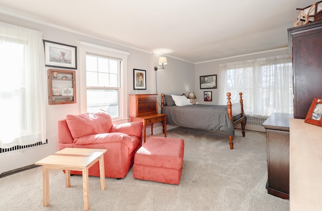 carpeted bedroom with ornamental molding and multiple windows