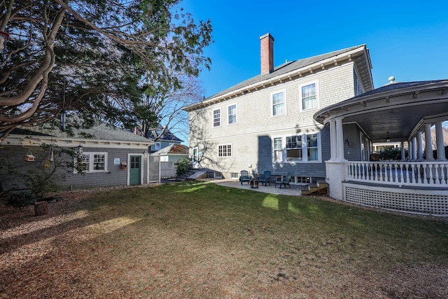 back of property featuring a yard and a patio area