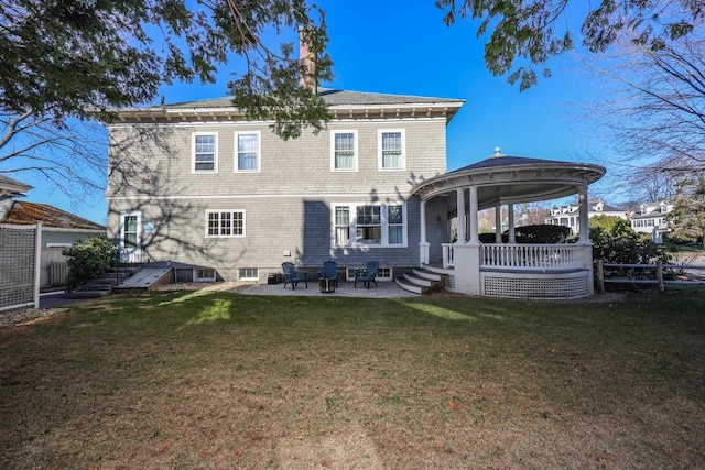 rear view of house featuring a gazebo, a yard, and a patio area