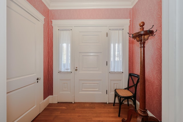 foyer with wood-type flooring and crown molding