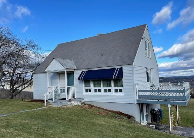 rear view of house with a yard and a deck