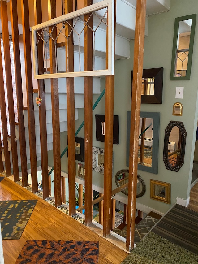 stairs with hardwood / wood-style floors