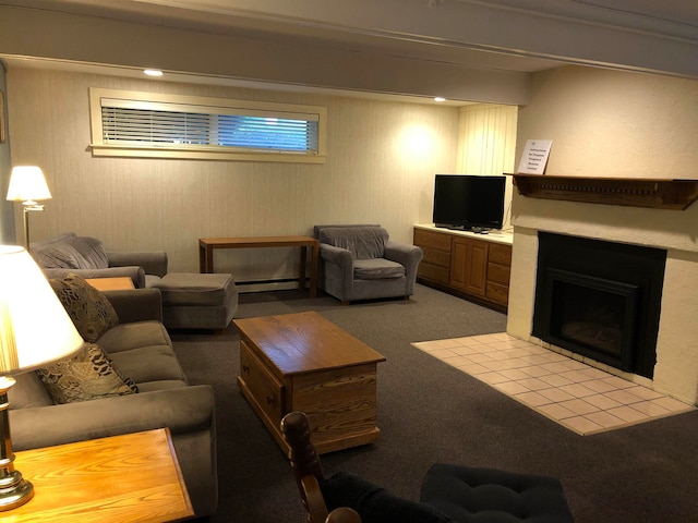 living area with a baseboard radiator, a fireplace with flush hearth, and carpet