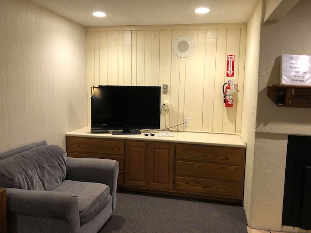 living area with recessed lighting and dark carpet