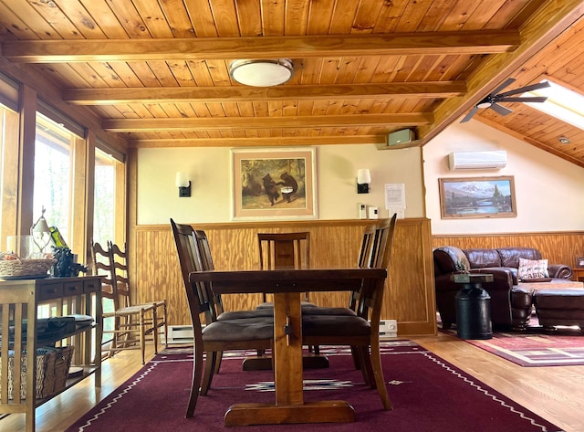 dining area with hardwood / wood-style floors, wood walls, wood ceiling, and a wall mounted AC