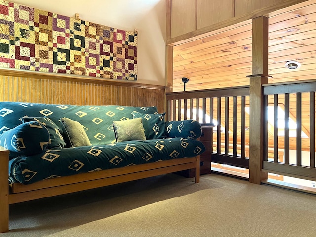 sitting room with carpet flooring and wood walls