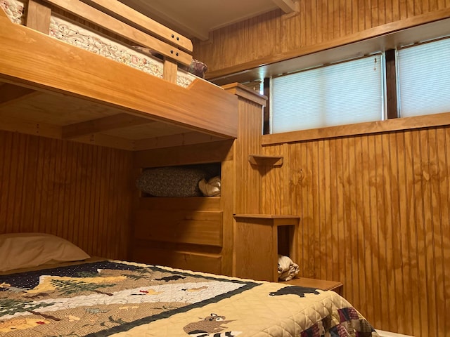 bedroom featuring wooden walls