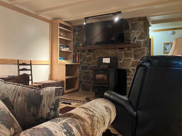 living room with beam ceiling and a wood stove