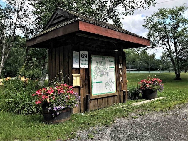 view of outbuilding featuring a lawn