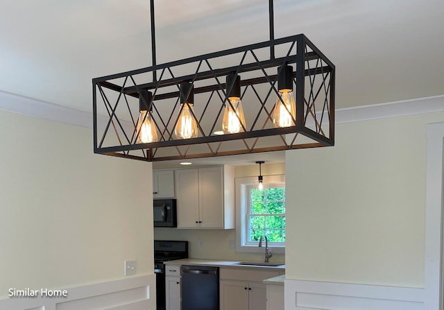 kitchen featuring white cabinetry, black appliances, sink, ornamental molding, and pendant lighting