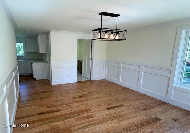 unfurnished dining area featuring light hardwood / wood-style floors