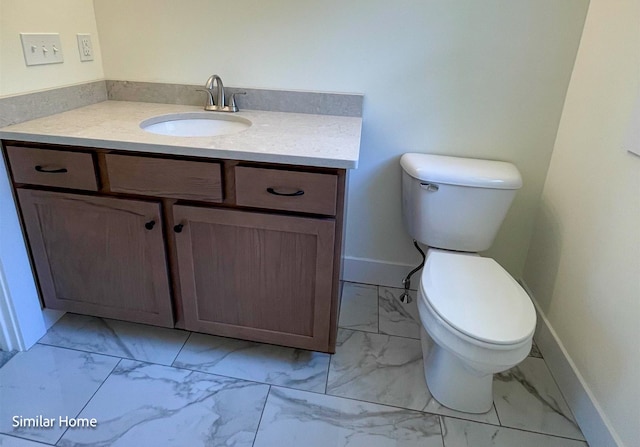 bathroom with toilet and vanity