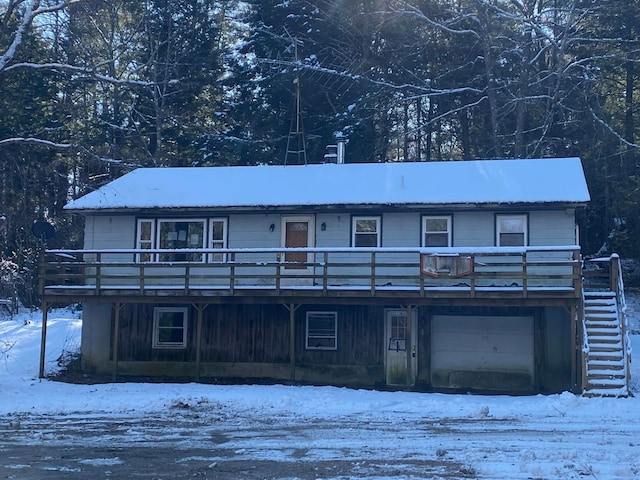 view of front of home featuring a garage and a wooden deck