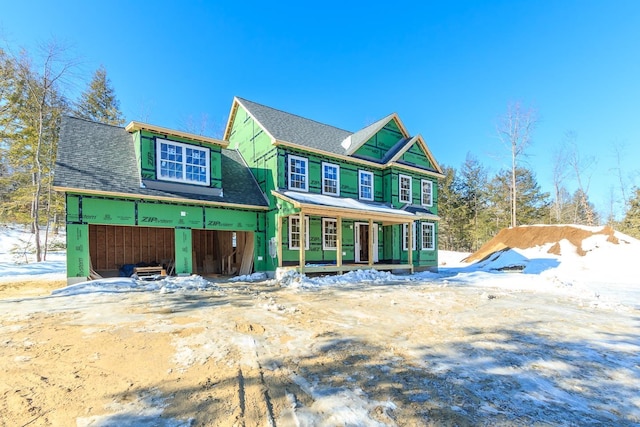 view of front of property featuring driveway and roof with shingles