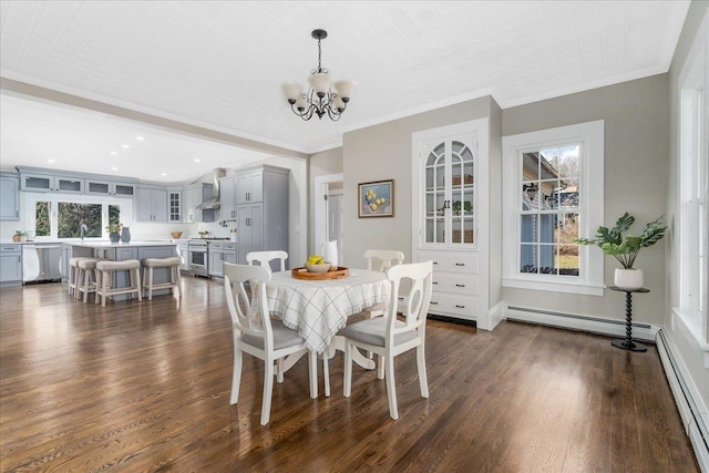 dining space with sink, crown molding, dark hardwood / wood-style floors, a baseboard radiator, and a chandelier