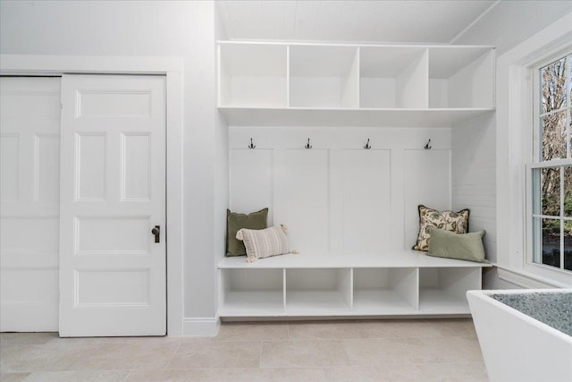 mudroom with plenty of natural light and light tile patterned floors