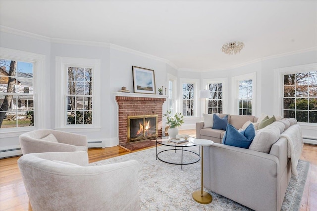 living room featuring hardwood / wood-style floors, ornamental molding, a fireplace, and baseboard heating