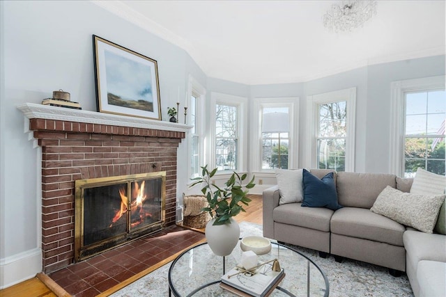 living room with ornamental molding, a brick fireplace, a wealth of natural light, and dark wood-type flooring