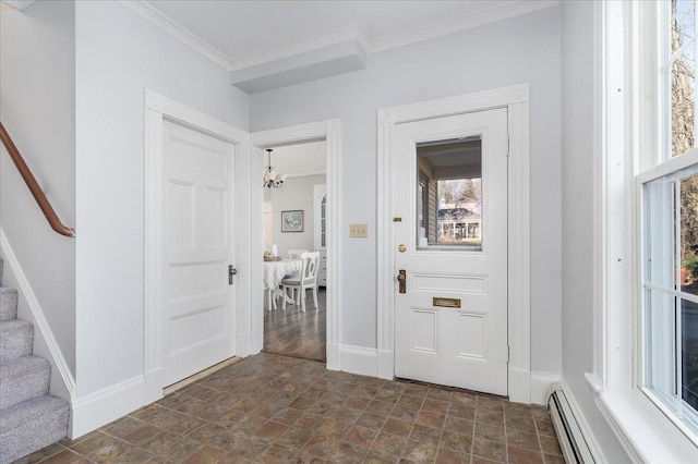 foyer with ornamental molding and a baseboard heating unit