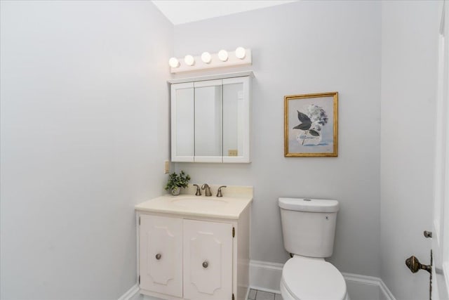 bathroom with tile patterned floors, vanity, and toilet