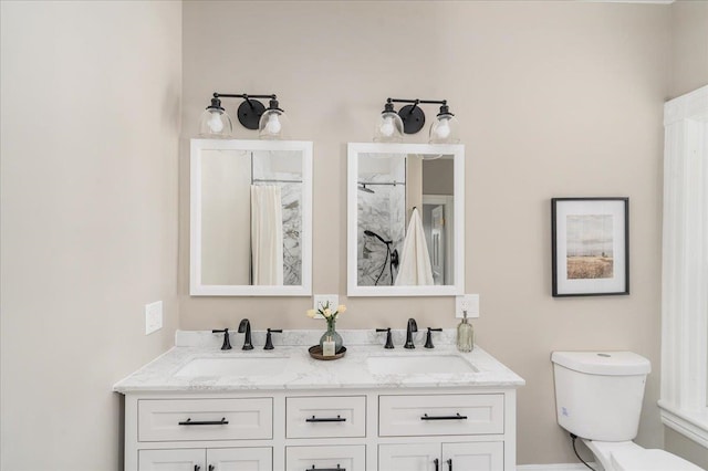 bathroom featuring vanity, toilet, and curtained shower