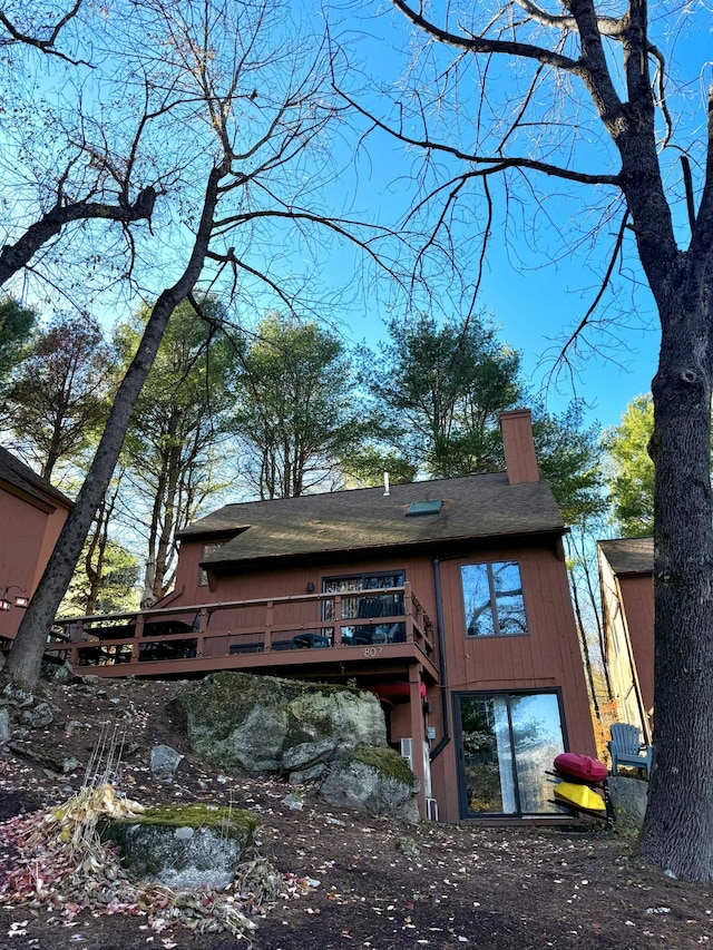 back of property with a wooden deck